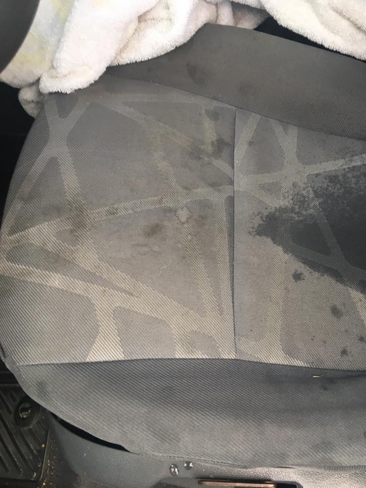 Car seat before cleaning β heavily stained fabric
